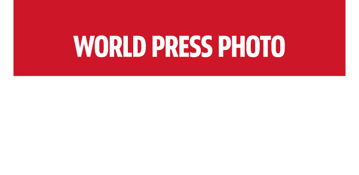 Red banner with bold white text centered, reading WORLD PRESS PHOTO. The bottom part of the image is blank white, promoting the World Press Photo Exhibition 2025 at Brisbane Powerhouse.