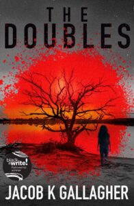 A silhouette of a girl stands by a barren tree at sunset, with red splatters overlaying the image. The title “The Doubles” appears at the top, and the author “Jacob K Gallagher” is at the bottom.