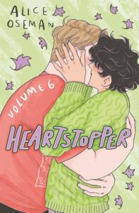 Illustrated cover of Heartstopper Volume 6 by Alice Oseman shows two boys sharing an intimate kiss, surrounded by purple leaves on a green background. The title is in bold, stylized text.