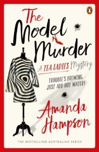 Book cover of “The Model Murder” by Amanda Hampson. Features a mannequin wearing a black and white striped dress, bullet holes, and playful fonts. Tagline reads: “Trouble’s brewing. Just add hot water!”.