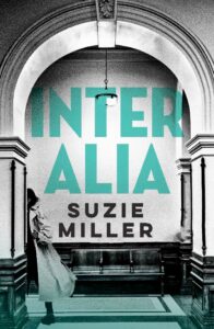 A person in a trench coat walks under an archway inside a building. Large teal text reads INTER ALIA, with SUZIE MILLER written in black beneath it.