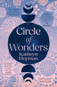 Book cover for Circle of Wonders by Kathryn Heyman, featuring a large navy circle, crescent moons, and floral patterns on a pink background, with several praise quotes from other authors.