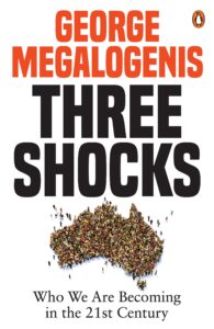 Book cover for Three Shocks by George Megalogenis, featuring large text and an outline of Australia filled with a crowd of people. Subtitle: Who We Are Becoming in the 21st Century. Penguin Books logo in top right.