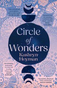 Book cover for Circle of Wonders by Kathryn Heyman, featuring blue crescent moons, stars, and floral patterns on a pink background, with praise from various authors.