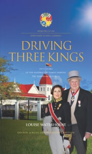 A man and woman in formal attire stand in front of a traditional building with white fencing. The book cover text reads “Driving Three Kings” and mentions Louise Waterhouse and fifty years serving the Kingdom of Tonga.